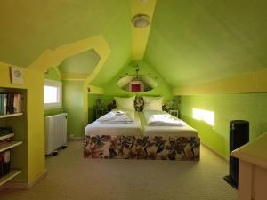 a green bedroom with a bed in a room at FerienSchlösschen Zell in Zell an der Mosel