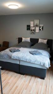 a bedroom with a bed with a blue comforter at Industrialdesign Düren in Düren - Eifel