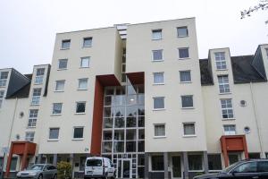 a large white building with a lot of windows at Industrialdesign Düren in Düren - Eifel