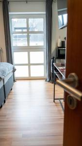a room with a large window and a bed and a door at Industrialdesign Düren in Düren - Eifel +8 photos