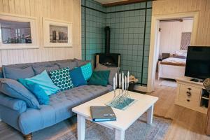 a living room with a couch and a table at Ferienhaus NATURlich Wassermuhle in Kappeln