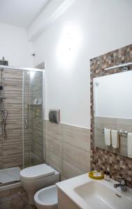 a bathroom with a toilet and a sink and a shower at Blu Mare Lampedusa Bed And Breakfast in Lampedusa