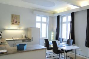 a kitchen and dining room with a table and chairs at Amanda in Kappeln