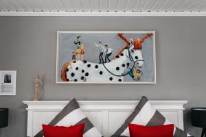 a painting of people on a horse on a wall at Ferienhaus Kleiner Onkel in Grödersby