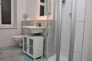 a bathroom with a sink and a toilet and a shower at Seestern in Kappeln +7 photos