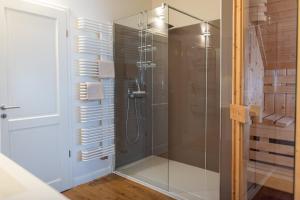 a bathroom with a shower with a glass door at Hus im Lee un Luv in Olpenitz +22 photos