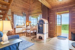 a living room with a wood stove in a cabin at Mein Blockhaus in Hasselberg