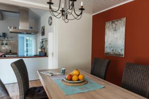 a dining room table with a bowl of fruit on it at Altes Kapitänshaus in Arnis +28 photos