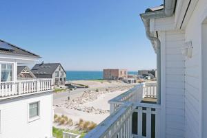 a view of the beach from a balcony of a house at The Beach House in Olpenitz