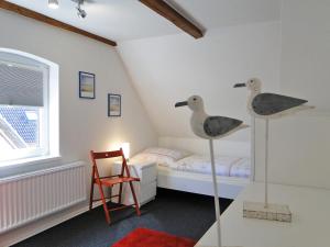 a room with a bedroom with a bed and two toy ducks at Skrey's To Hus in Kappeln +14 photos