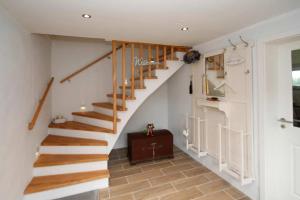 a staircase in a home with white walls at Dornröschen in Brarupholz