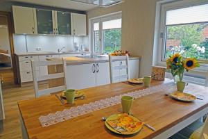 a kitchen with a wooden table with food on it at Mee(h)r in Hasselberg