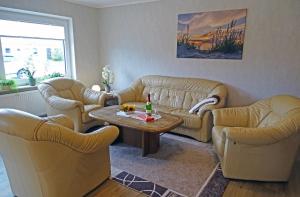a living room with two couches and a coffee table at Mee(h)r in Hasselberg