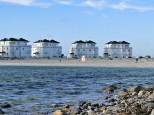 a row of houses on the beach near the water at Flow in Kappeln