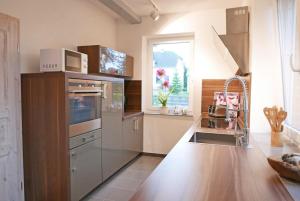 a kitchen with stainless steel appliances and a window at Ferienhaus Richter in Lindau