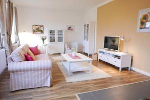 a living room with a couch and a tv at Schleistern in Kappeln