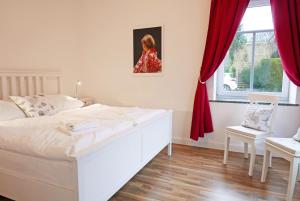 a bedroom with a white bed and a window at Schleistern in Kappeln