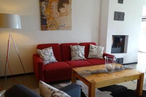 a living room with a red couch and a coffee table at Vincent in Kappeln