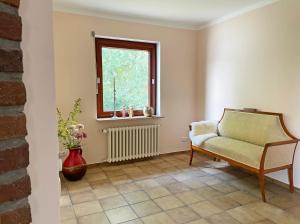 a living room with a chair and a window at Stadtoase in Süderbrarup +17 photos