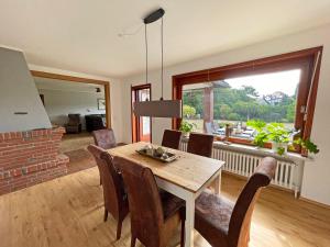 a dining room with a table and chairs and a fireplace at Stadtoase in Süderbrarup