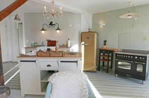 a kitchen with a refrigerator and a table in it at Hafenheimat in Kappeln