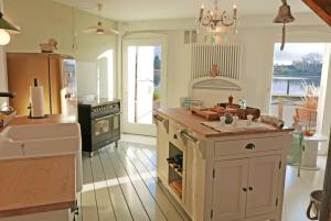 a kitchen with a sink and a stove top oven at Hafenheimat in Kappeln +19 photos