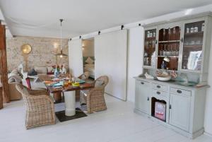 a kitchen and dining room with a table and chairs at Hafenheimat in Kappeln +19 photos