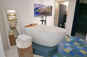 a large white bath tub sitting in a bathroom at Hafenheimat in Kappeln