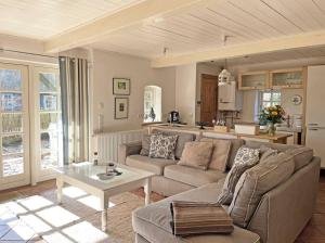 a living room with a couch and a table at Lille Skov in Rabenkirchen