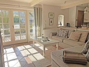 a living room with a couch and a table at Lille Skov in Rabenkirchen