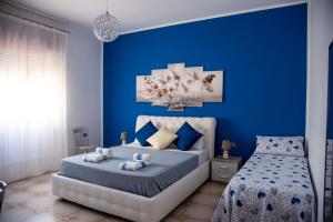 a blue bedroom with a bed with blue walls at Blu Mare Lampedusa Bed And Breakfast in Lampedusa