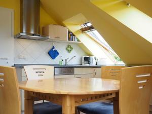 プレローにあるHaus am Brunnen Apartment 50のキッチン(木製テーブル付)