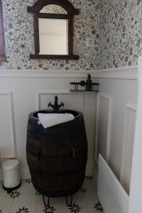 a bathroom with a barrel sink and a mirror at EgerCottages - Bikavér Cottage in Eger