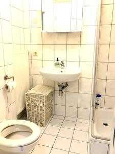 a bathroom with a toilet and a sink at Quiet beautiful apartment in Tuttlingen