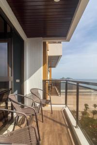 a balcony with chairs and a view of the beach at Apartment Ocean View II in Rio de Janeiro