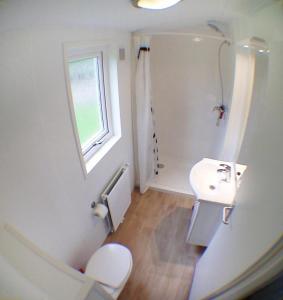 a white bathroom with a sink and a toilet at "ATHEN " - Studio mit Sandstrand & Seeblick nahe Rhein-Main und Spessart in Kahl am Main