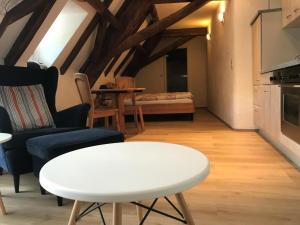 a living room with a white table and a couch at Springiersbacher Hof in Ediger-Eller