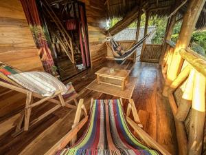 a room with a hammock in a cabin at Casa La Aventura Guasacate - Popoyo in Popoyo