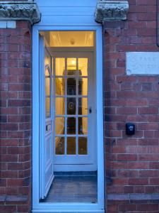 a door into a brick building with a brick wall at Central Doncaster 5BED 3BATH ParkView Mansion in Doncaster