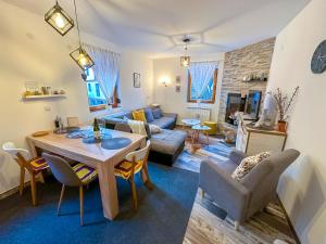 a living room with a table and a couch at Praška zima in Jahorina