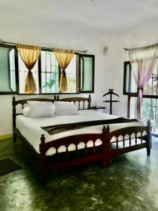 a bedroom with a large bed in a room with windows at Jolie Jungle Eco Hotel in Puerto Morelos