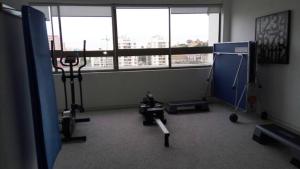 a gym with exercise equipment in a room with windows at Arriendo en centro de Viña in Viña del Mar