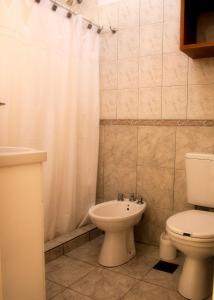 a bathroom with a toilet and a sink at Balcones del Pilar in Colón