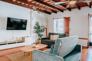 a living room with two chairs and a table at Charming & Spacious Apt W/ Views @ Old San Juan in San Juan