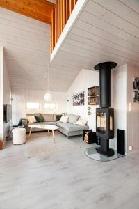 a living room with a fireplace and a couch at Vaeranes- Ny hytte med flott utsikt in Ramberg