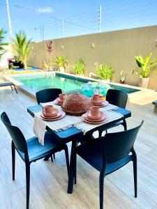 einen Tisch mit Tellern und Geschirr in einem Pool in der Unterkunft Casa Encanto das Dunas in Santo Amaro