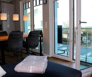 a room with a table and chairs and a large window at Objekt 96 - Appartement Meerblick in Häven