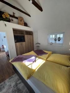 a bedroom with two beds with yellow sheets at Ammerland 2 in Bad Zwischenahn