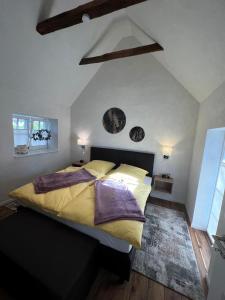 a bedroom with a large bed with yellow sheets at Ammerland 2 in Bad Zwischenahn