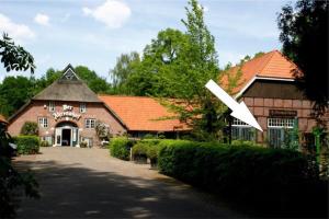 a large brick building with a white arrow on it at Ammerland 2 in Bad Zwischenahn